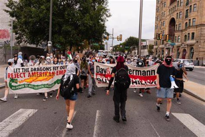 Demonstrators march to entrance of KKK national director Thomas Robb's