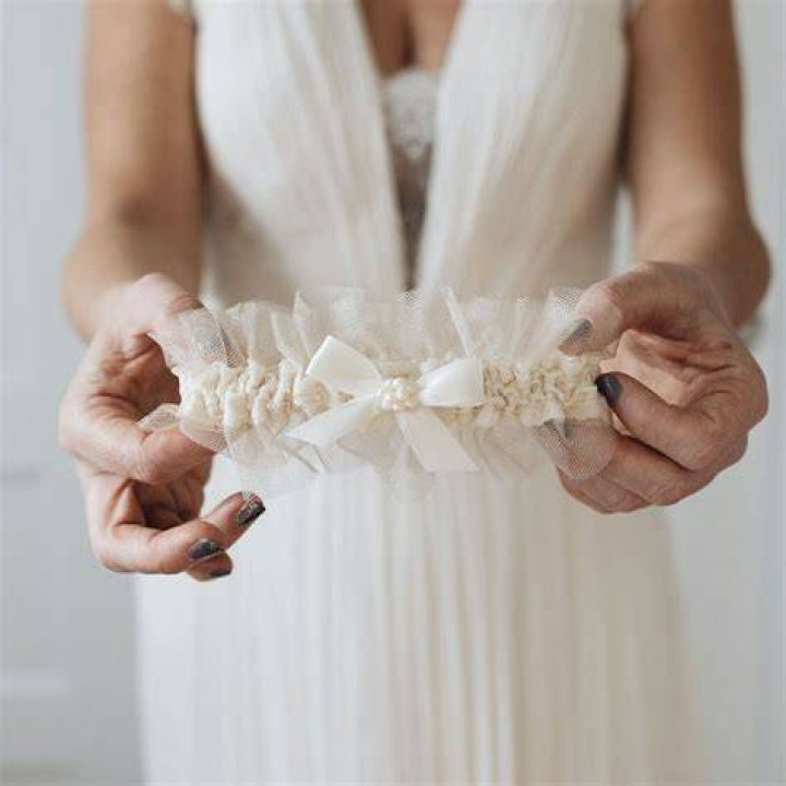 Does a bride buy her own garter?