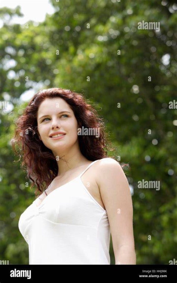 the woman is wearing all black and posing for pictures