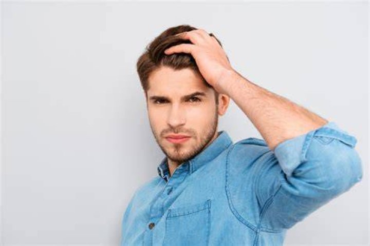 What does it mean when a guy runs fingers through his hair?